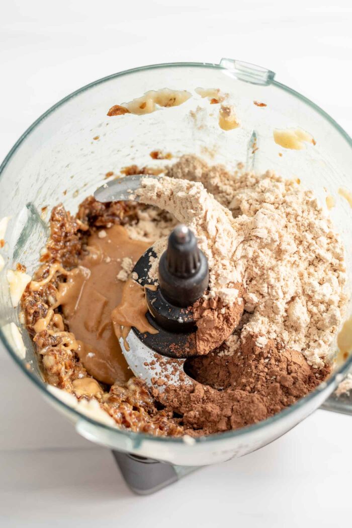 Protein powder, cocoa powder and peanut butter in a food processor.