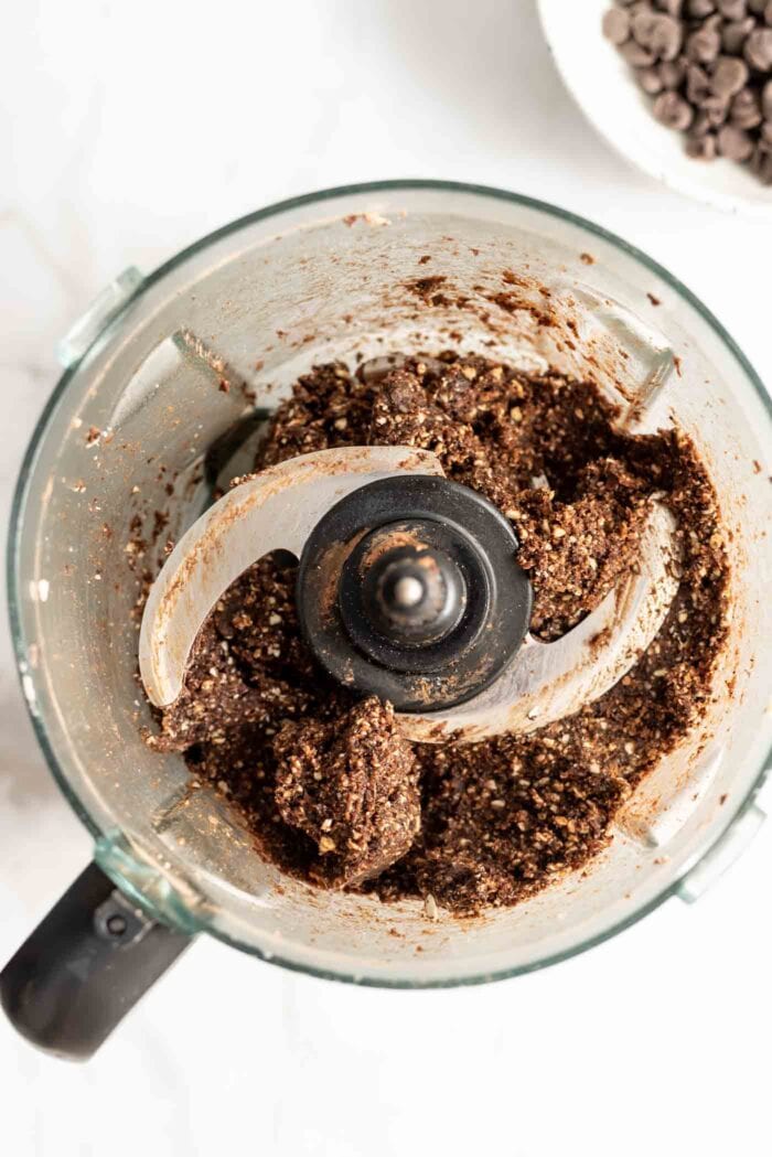 Thick, sticky chocolate dough blended up in a food processor.