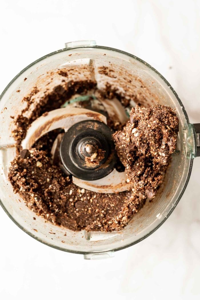 Chocolate dough with chocolate chips in it blended together in a food processor.
