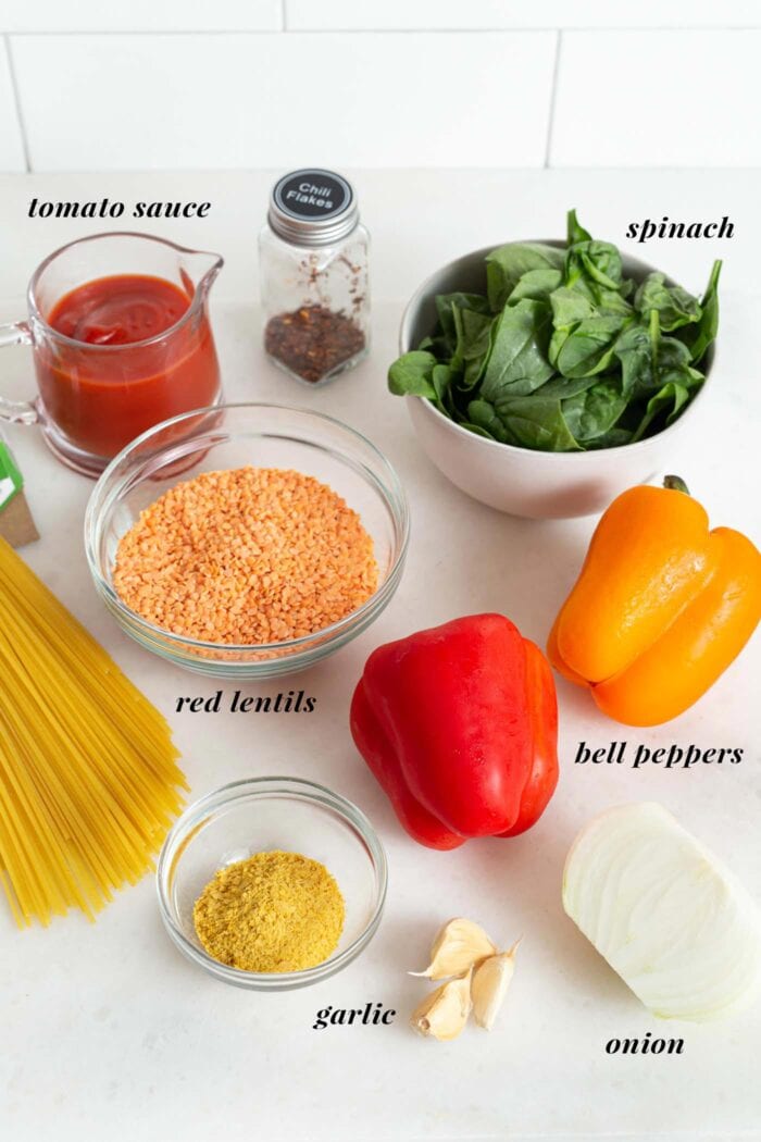 Labelled ingredients for making red lentil pasta sauce.