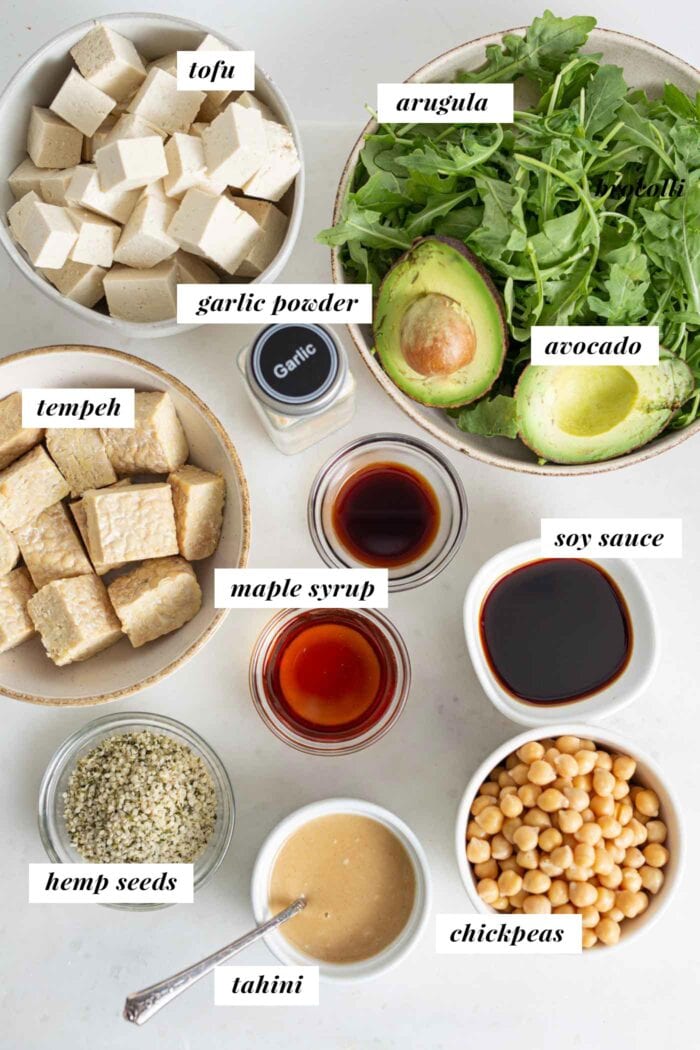 Labelled ingredients in bowls for making a vegan high-protein salad bowl.