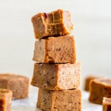 A stack of 4 pieces of pumpkin pie fudge.