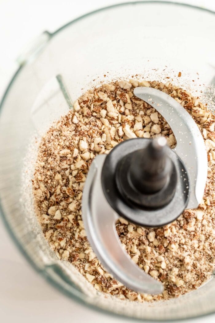 Blended almonds in a food processor container.