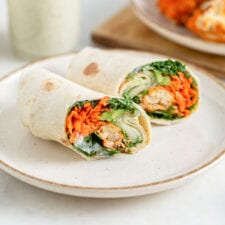 Wrap with buffalo cauliflower and avocado in it, sliced in half to show inside.