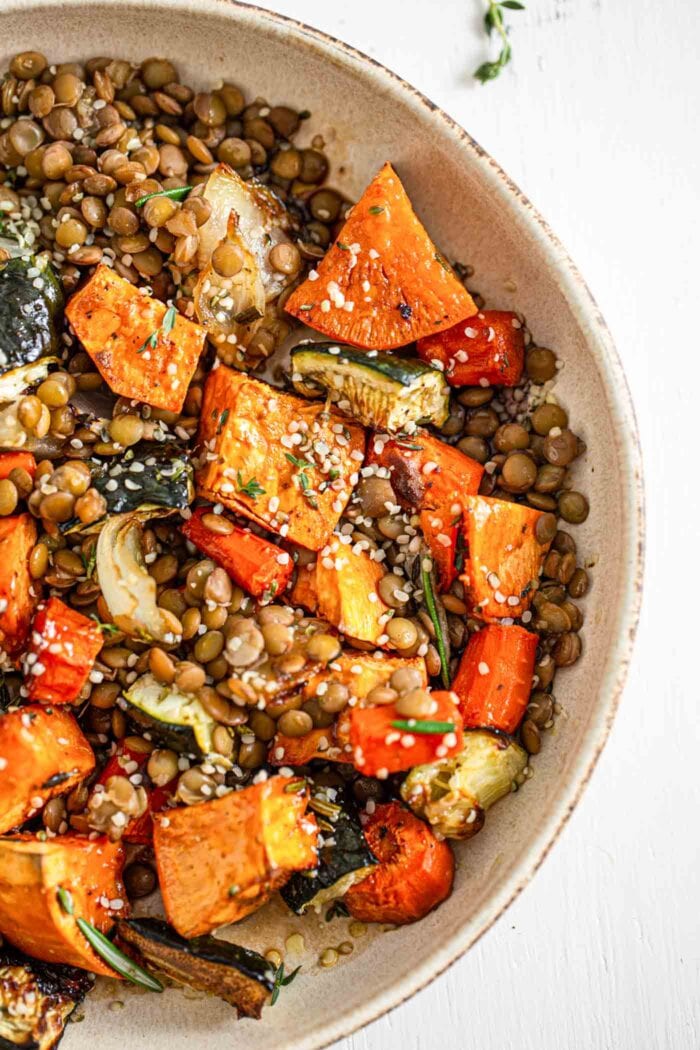 Overhead image of a bowl of roasted vegetables and lentils.