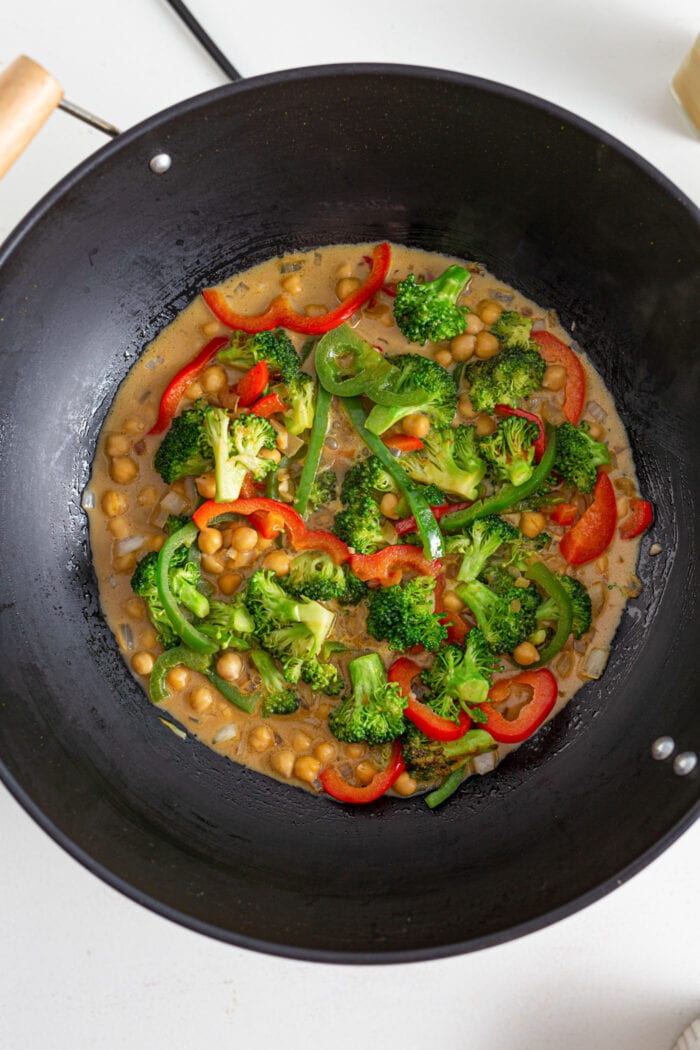 Overhead view of chickpea vegetable curry in a wok.