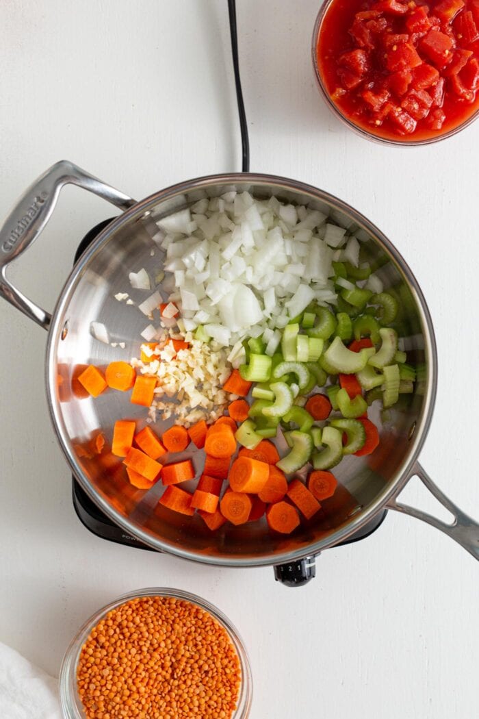 Onion, garlic, carrot and celery cooking in a skillet.