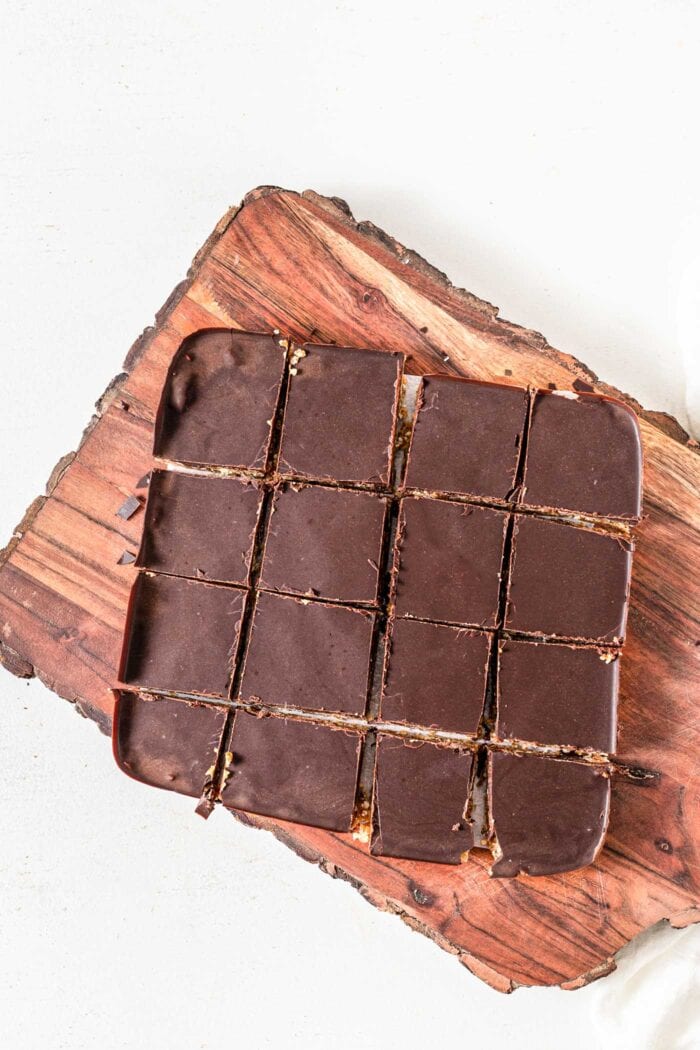 Overhead view of chocolate bars sliced into 12 bars on a cutting board.