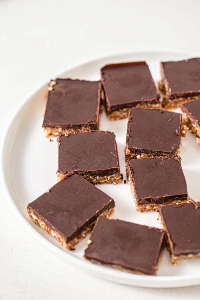 Plate of 7 chocolate coated cashew squares.