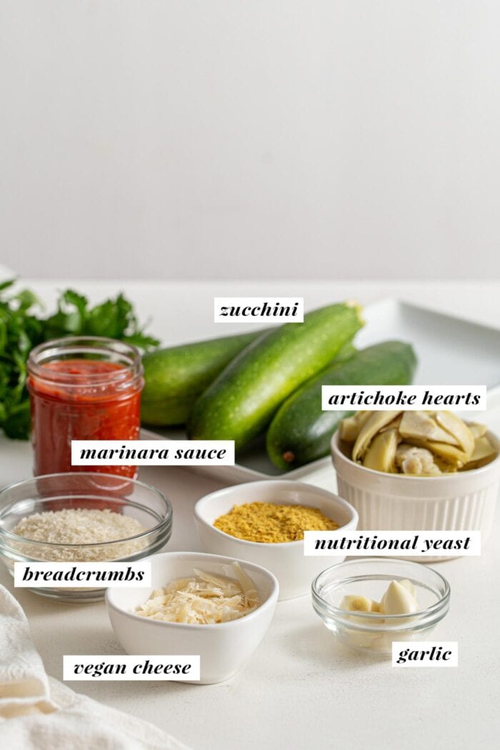 Ingredients for making stuffed zucchini boats labelled with text overlay.