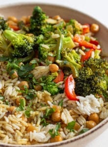 Bowl of rice, chickpeas and vegetables in a creamy curry sauce.
