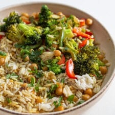 Bowl of rice, chickpeas and vegetables in a creamy curry sauce.