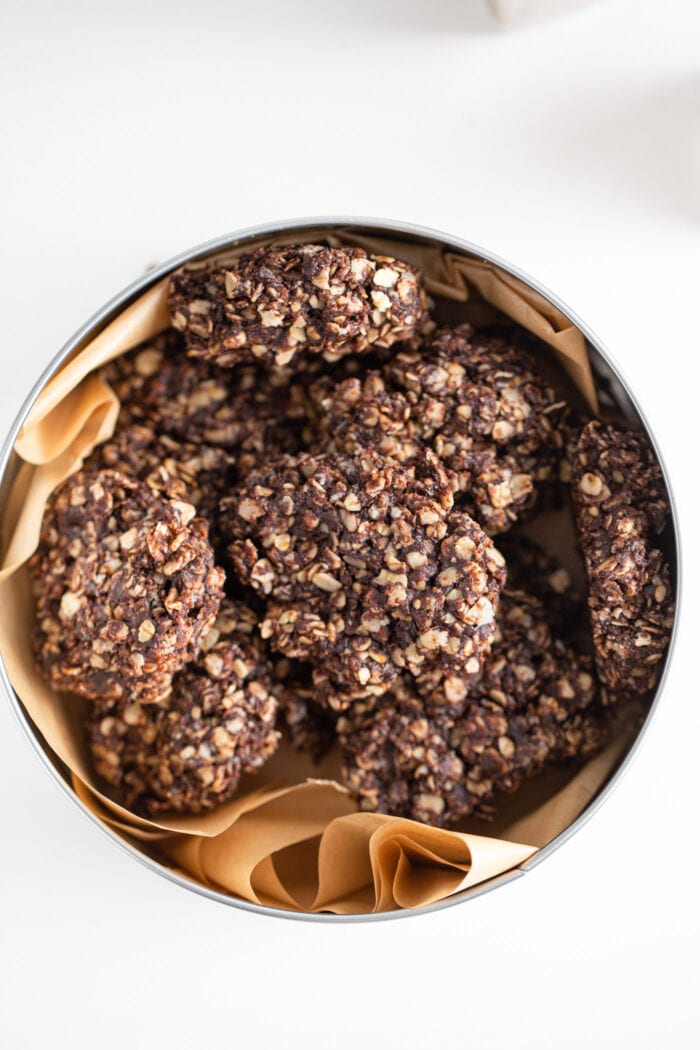 Overhead view of a tin of chocolate oatmeal cookies.