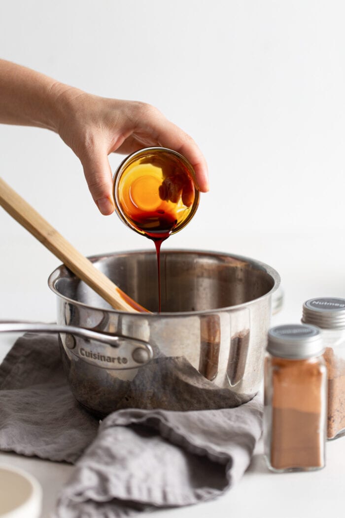 Pouring molasses into a saucepan.