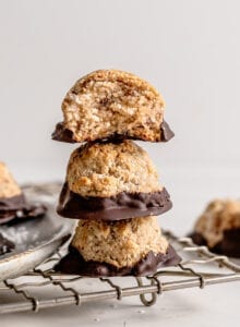 Stack of 3 coconut macaroons sitting on a cooling rack.