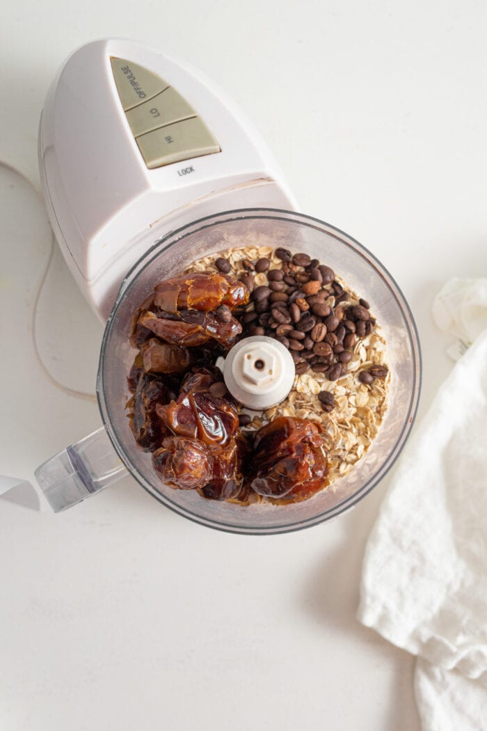 Dates, oats, coffee beans and vanilla in a food processor.