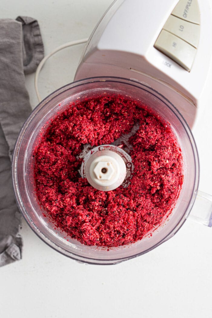 Raw blended beet burger mixture in a food processor.