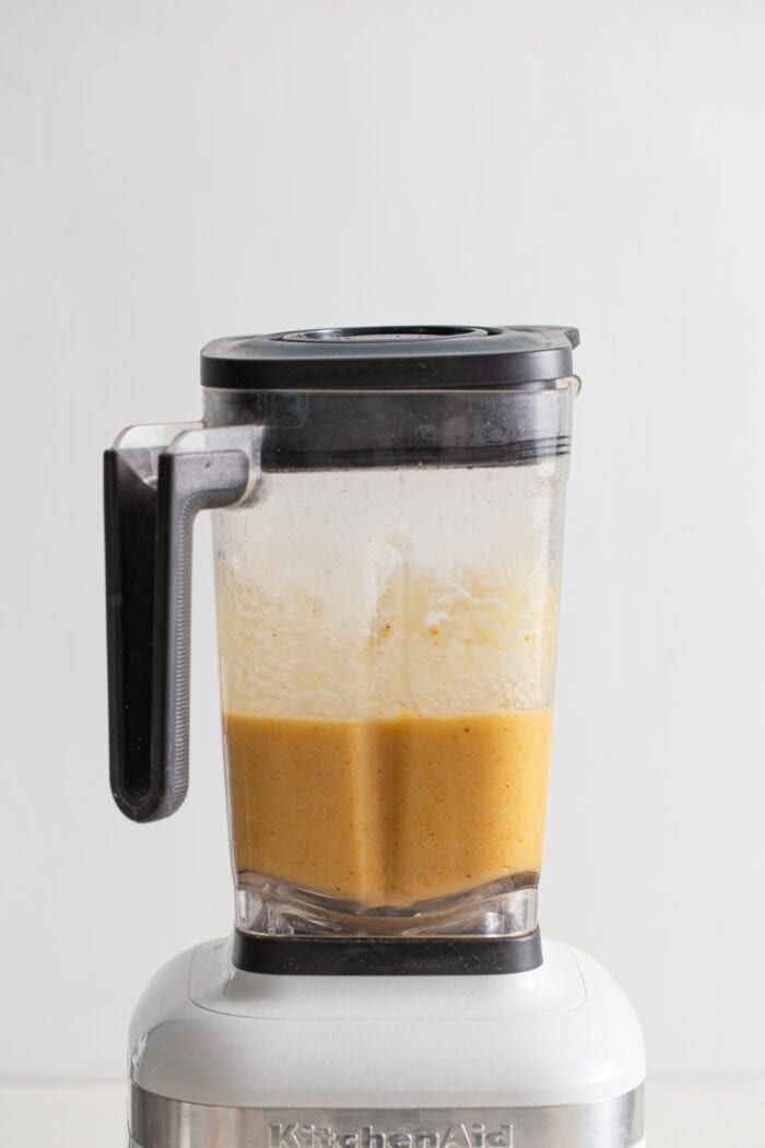 Creamy blended cauliflower soup in a blender.