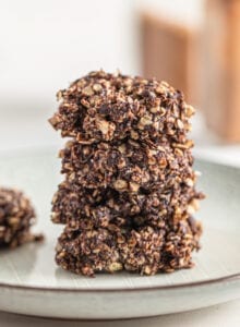 Stack of 4 chocolate no-bake oatmeal cookies on a small plate.