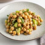 Curried chickpea salad with celery, walnuts and raisins on a plate.