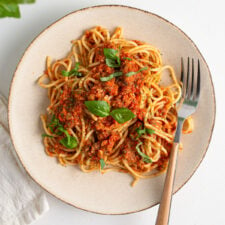 Overhead view of a plate of spaghetti and bolognese sauce.