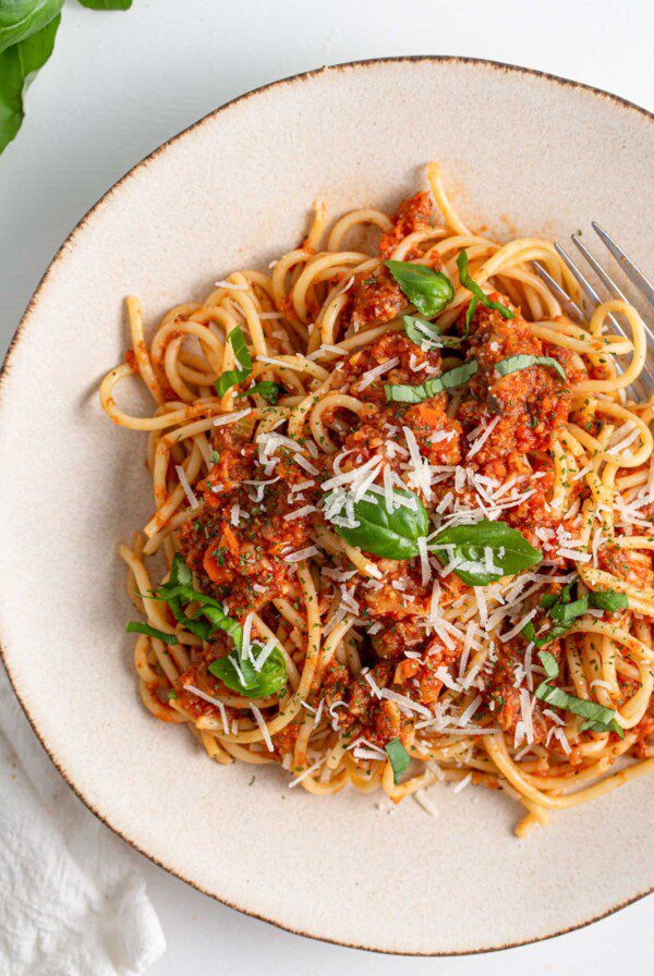 Overhead view of a plate of spaghetti and bolognese sauce.