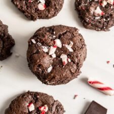 Overhead view of chocolate cookies topped with crushed candy canes.