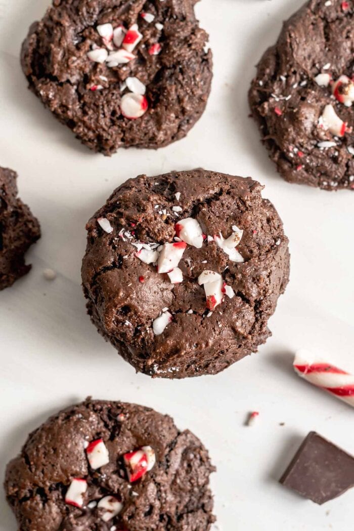 Overhead view of chocolate cookies topped with crushed candy canes.