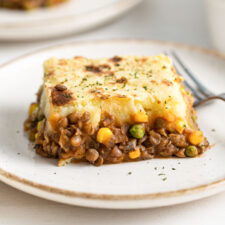 Large slice of lentil shepherd's pie on a plate.