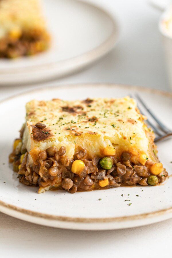 Large slice of lentil shepherd's pie on a plate.