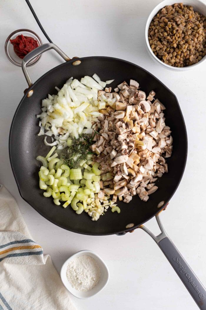 Mushroom, celery and onion cooking in a skillet.