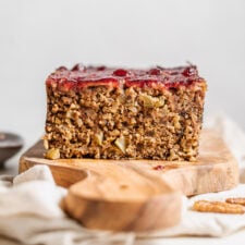 Close up of a sliced nut roast on a cutting board showing inside of loaf.