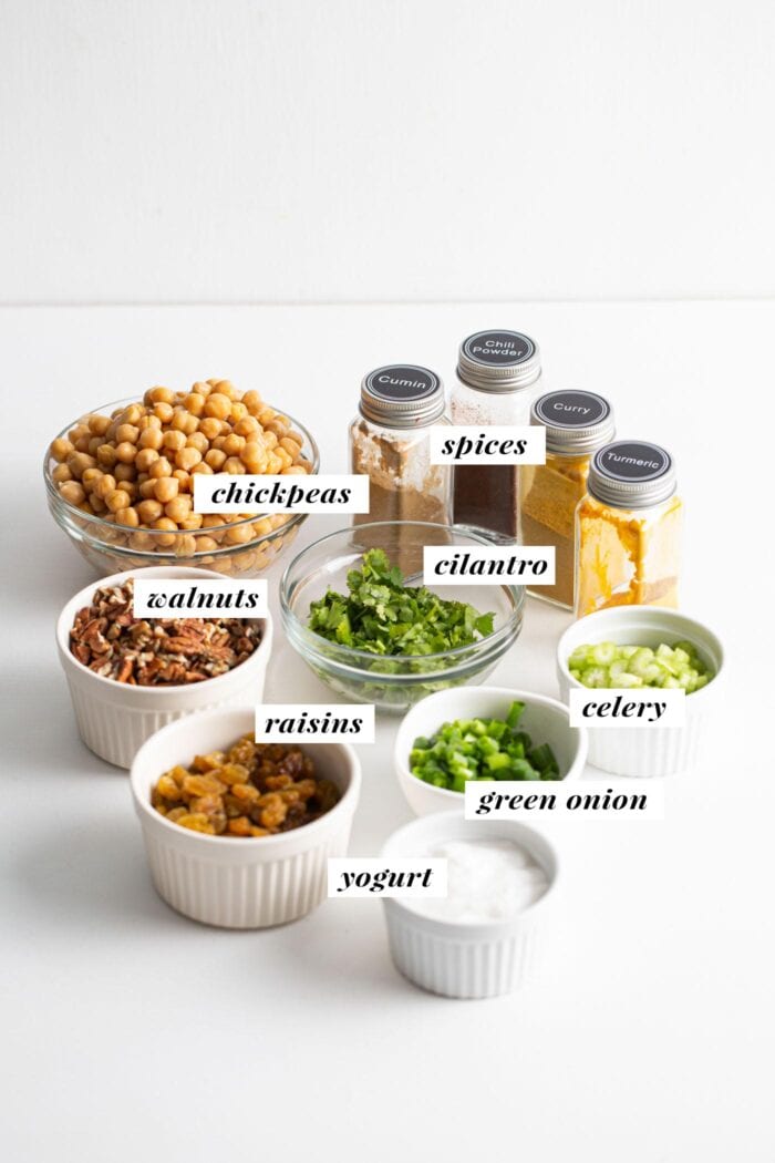 Visual of ingredients for making a curried chickpea salad recipe. Ingredients are labelled with text overlay.