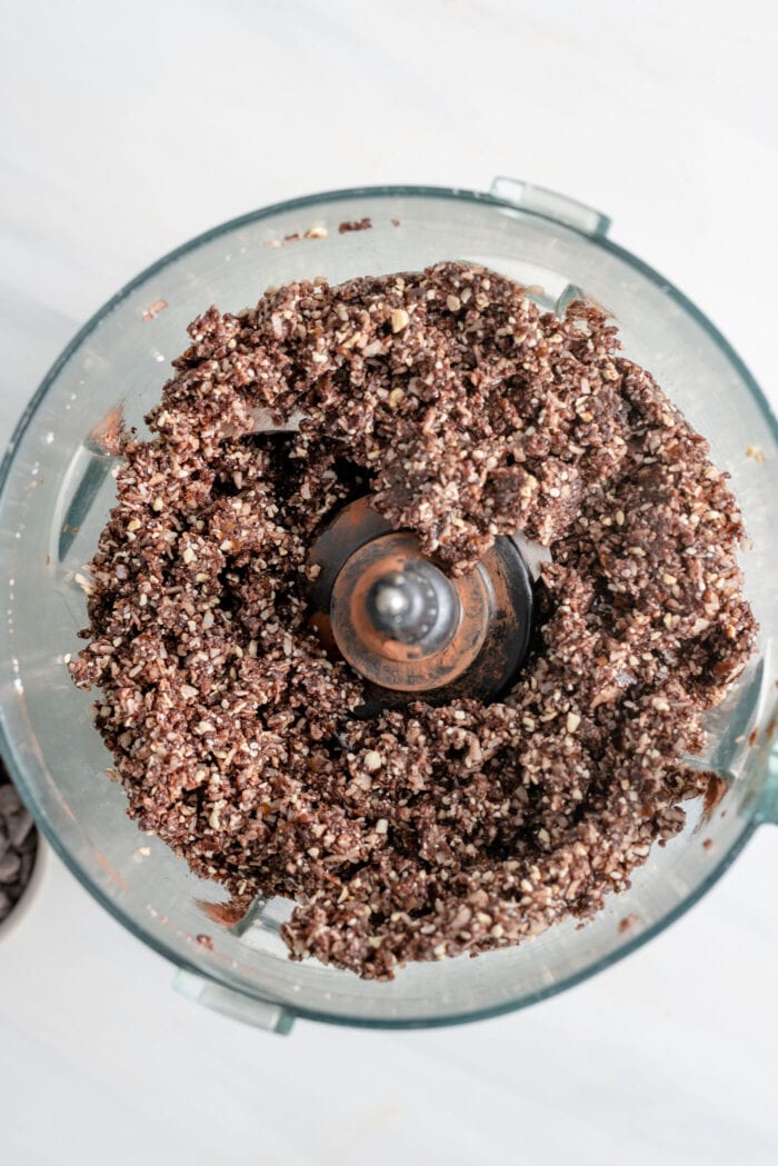 Blended, crumbly chocolate dough in a food processor.