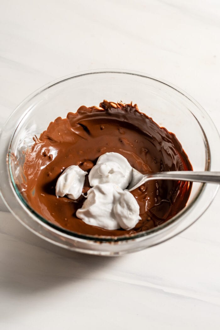 Coconut cream in a bowl with melted chocolate.
