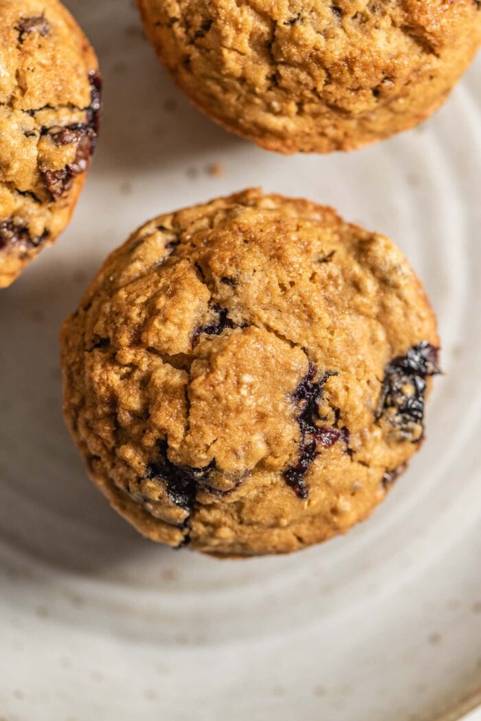 Overhead view of a close up of a chickpea flour muffins with blueberries and chocolate chips in it.