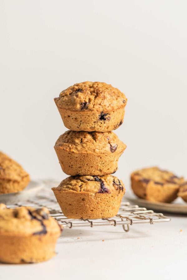 Stack of 3 muffins on a cooling rack.