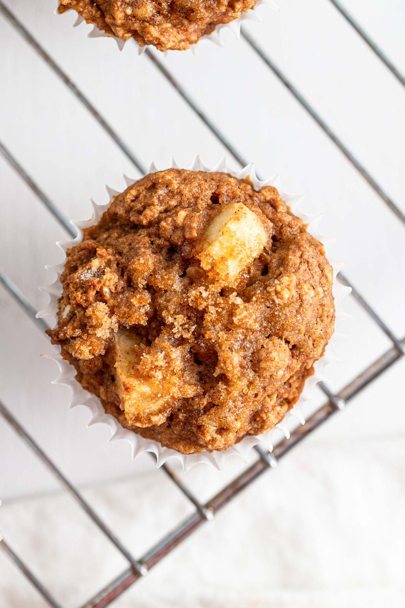 Overhead view of an apple muffin topped with brown sugar.