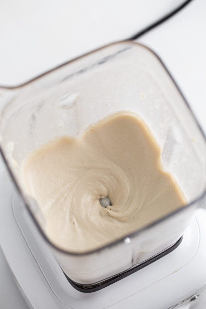 Creamy cashew frosting in a blender.