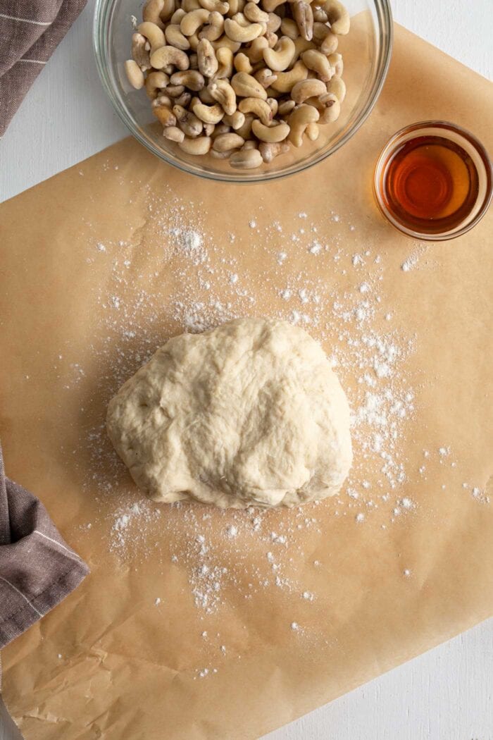 Cinnamon roll dough on a lightly floured surface.