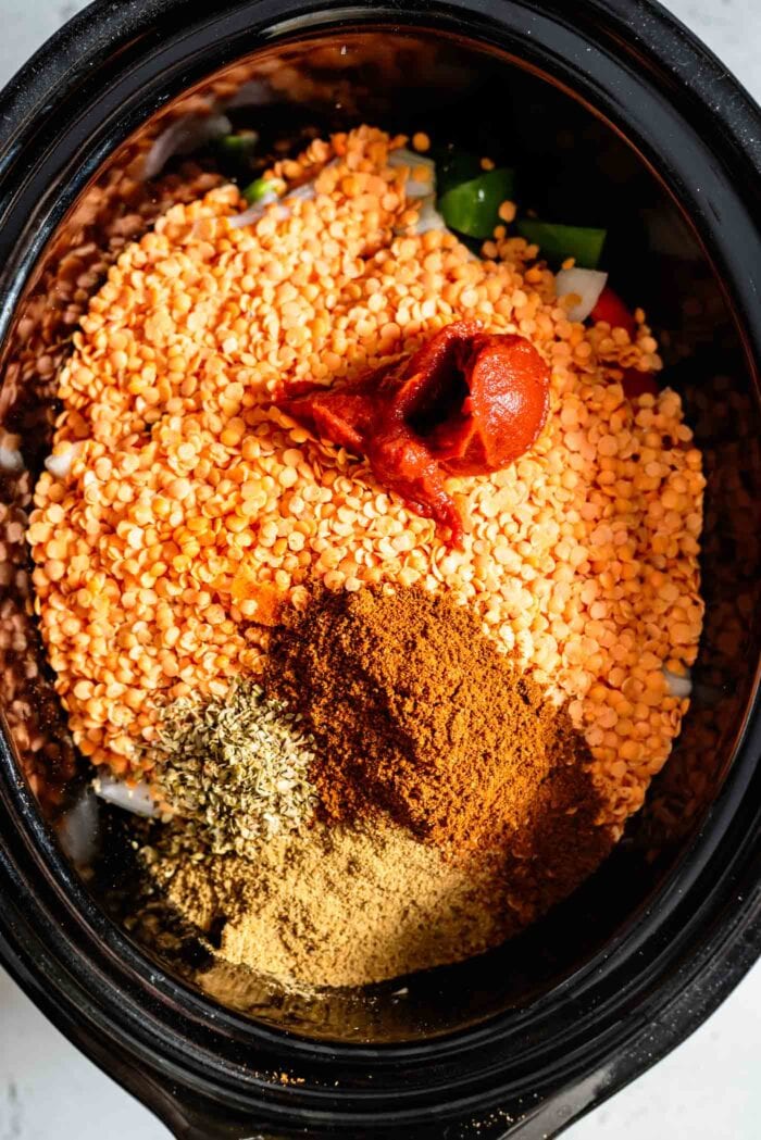 Red lentils, spices and tomato paste in a crockpot.