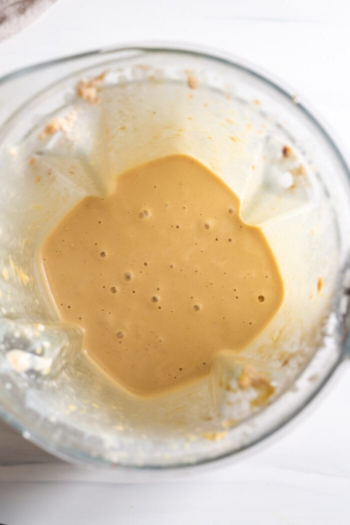 Creamy blended peanut butter protein shake in a blender container.