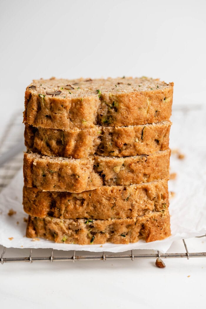 Close up of a stack of 5 thick slices of zucchini bread.