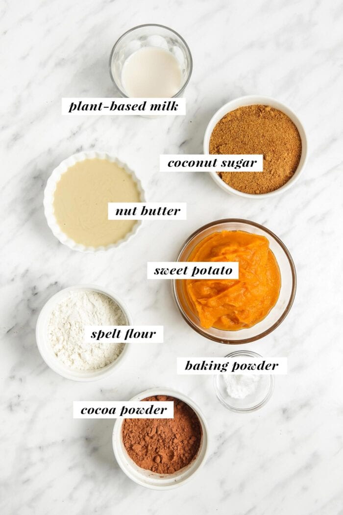 All the ingredients needed for making a sweet potato brownie recipe with pumpkin, almond butter and whole grain flour.