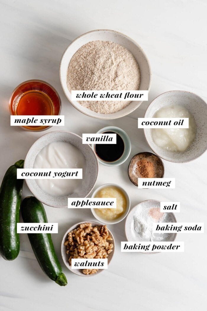 Visual of all ingredients needed for making a zucchini loaf labelled with text overlay.