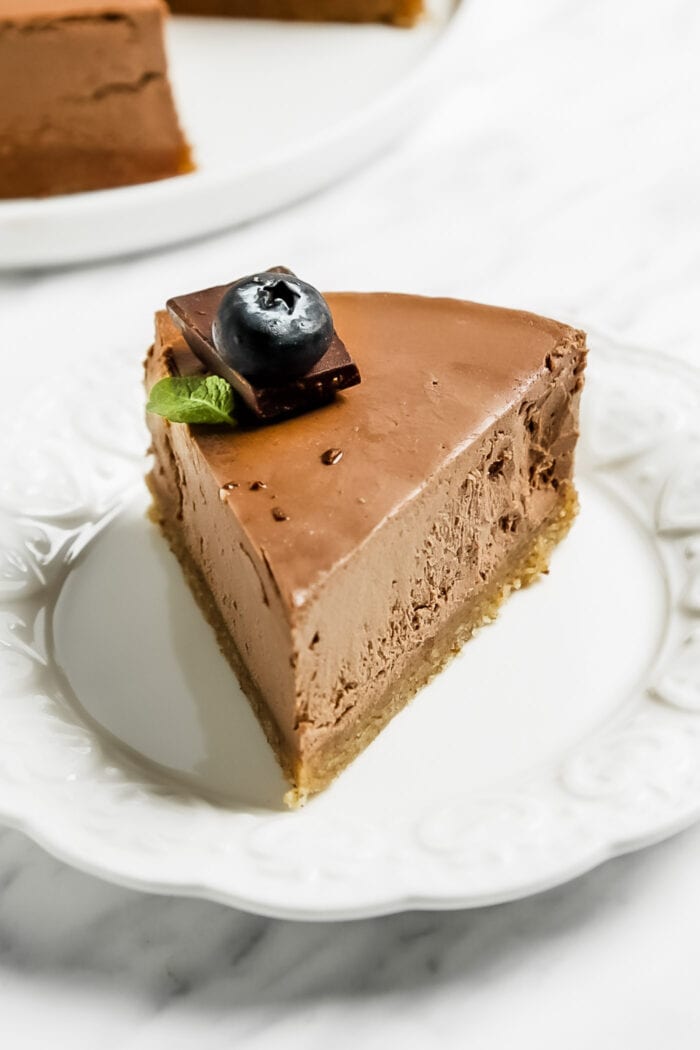 Slice of chocolate cheesecake on a small plate.