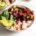 Dinner bowl with rice, bbq tofu, avocado, broccoli, pineapple and roasted red onion.