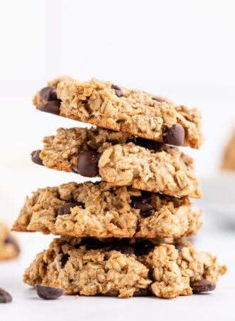 Stack of 4 chocolate chip cookies against a plain white background.