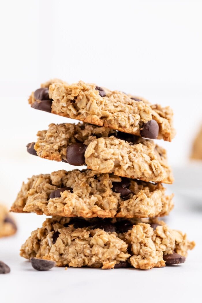 Stack of 4 chocolate chip cookies against a plain white background.