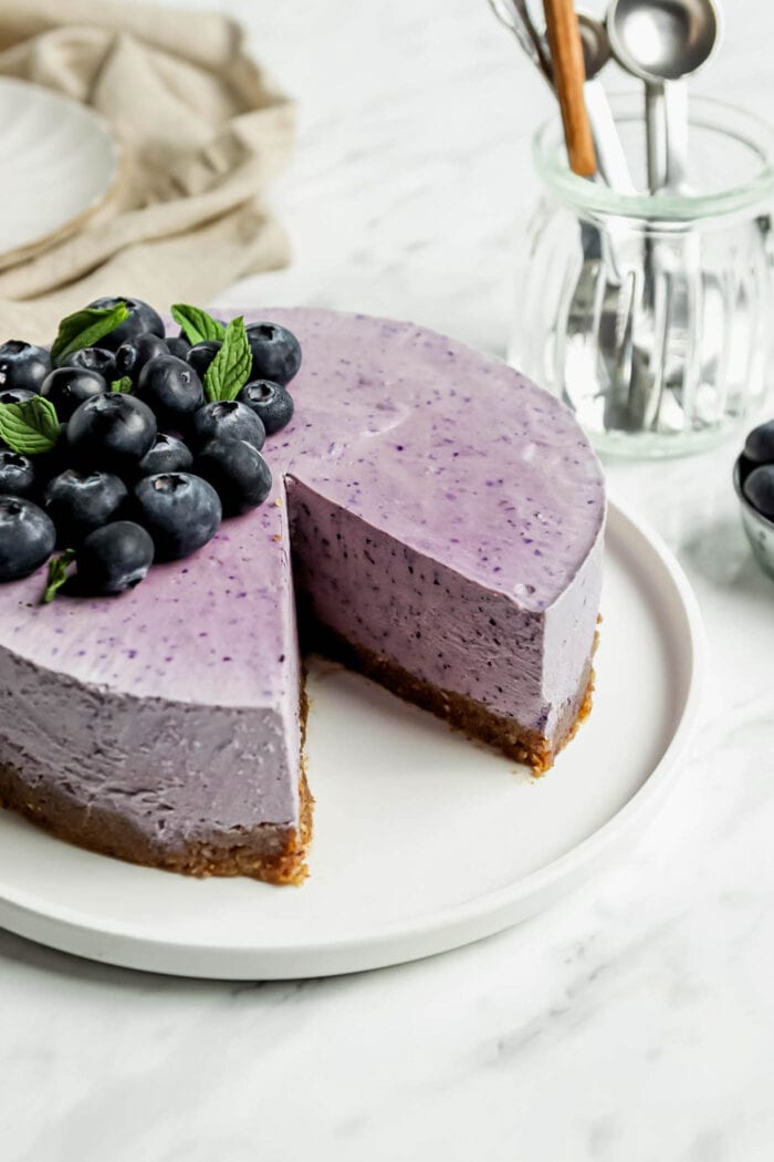 No-bake blueberry cheesecake with a slice cut out of it.